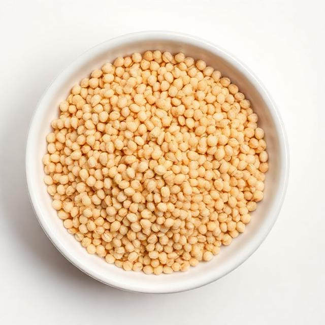 Top-down view of raw amaranth seeds in a white bowl