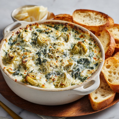 A creamy artichoke dip in a bowl.