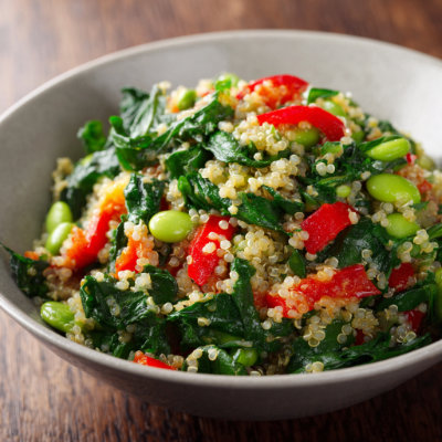 A bowl with edamame, quinoa, and spinach, on a white background with a NutrientShield logo.