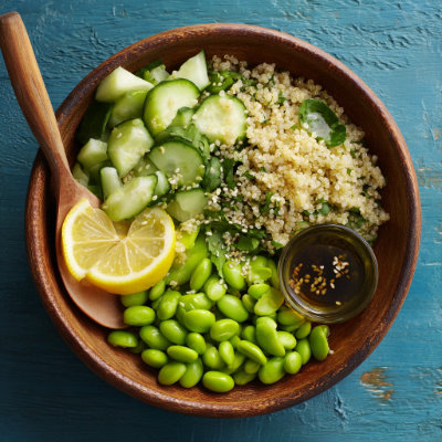 A fresh salad with edamame, quinoa, and cucumber, on a white background with a NutrientShield logo.