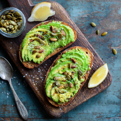 Toasted whole-grain bread with avocado and pumpkin seeds, on a white background with a NutrientShield logo.
