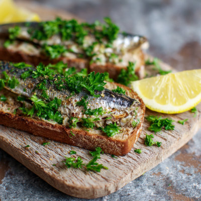 Sardines on whole-grain toast with parsley.