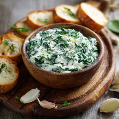 A creamy spinach dip in a bowl.